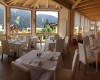 Elegantná reštaurácia s veľkými oknami a výhľadom na hory.
