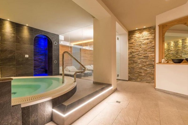 Moderné wellness centrum s vírivkou a kamennými stenami.
