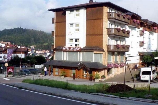 Hotel Andalo s kvetinami na balkónoch a horami v pozadí.